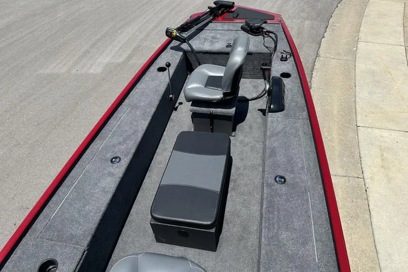 Slide: The Image of 2025 Tracker Panfish 17 boat interior with gray seating and red trim. - 8