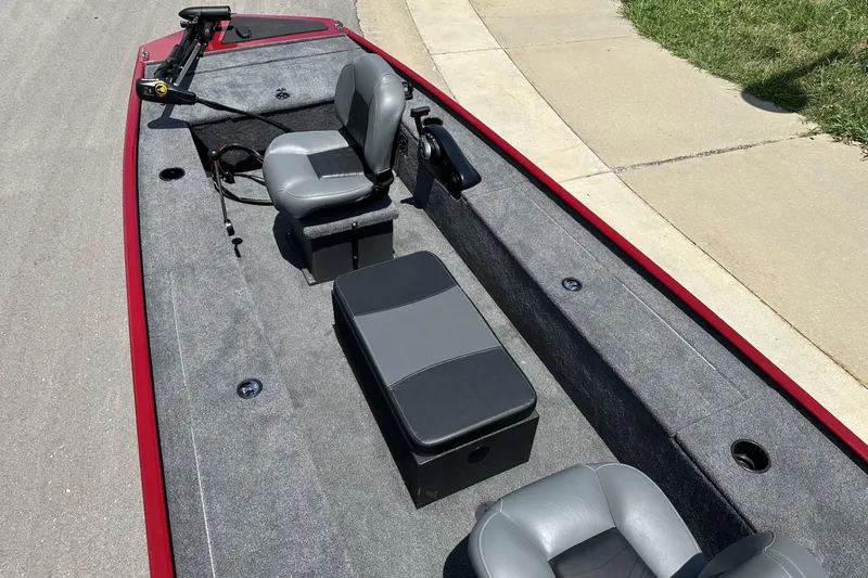 Slide: The Image of 2025 Tracker Panfish 17 boat interior with gray seating and red trim. - 6