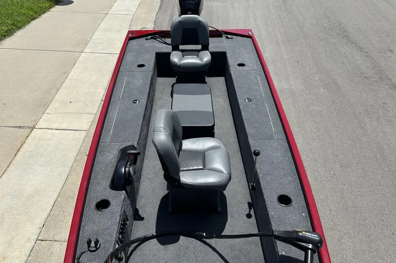 Slide: The Image of 2025 Tracker Panfish 17 boat interior with gray seating and fishing rod holders. - 7