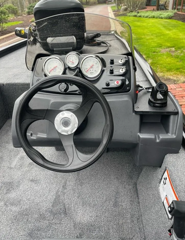 Slide: The Image of 2025 Tracker Pro 170 boat dashboard with steering wheel and gauges. - 6
