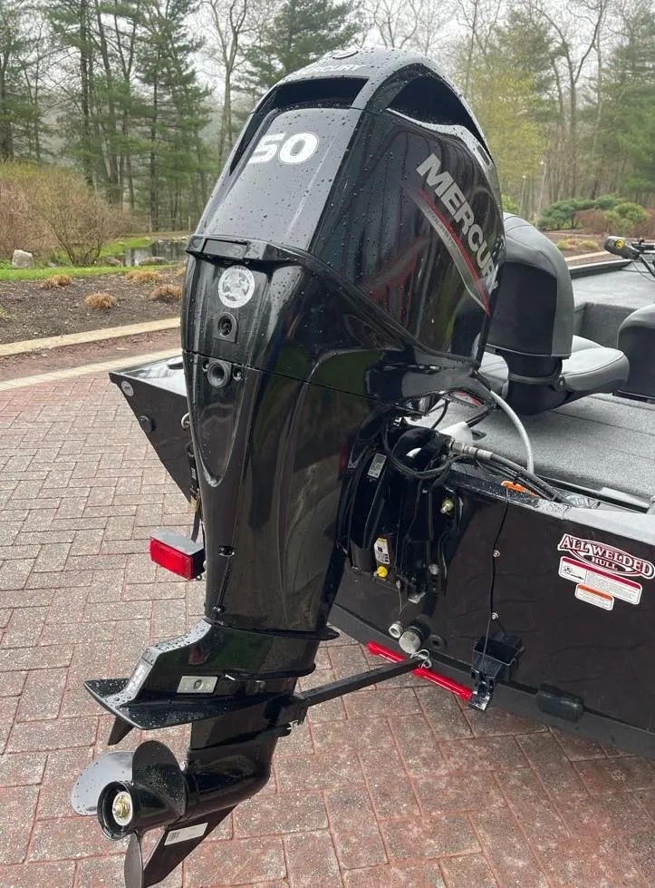 Slide: The Image of 2025 Tracker Pro 170 boat with Mercury 50 outboard motor, parked on brick driveway. - 7
