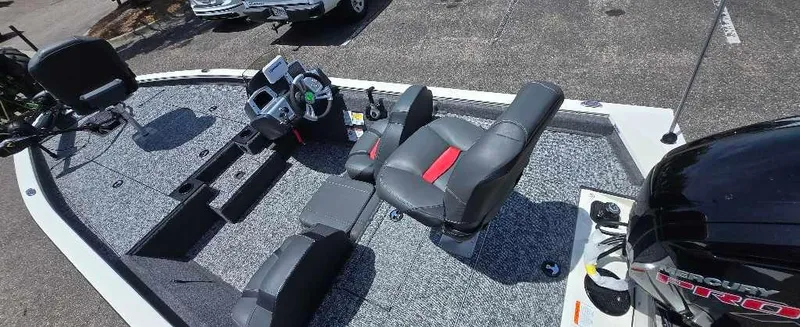 Slide: The Image of 2025 Tracker Pro Team 190 boat interior with seating and steering console. - 2