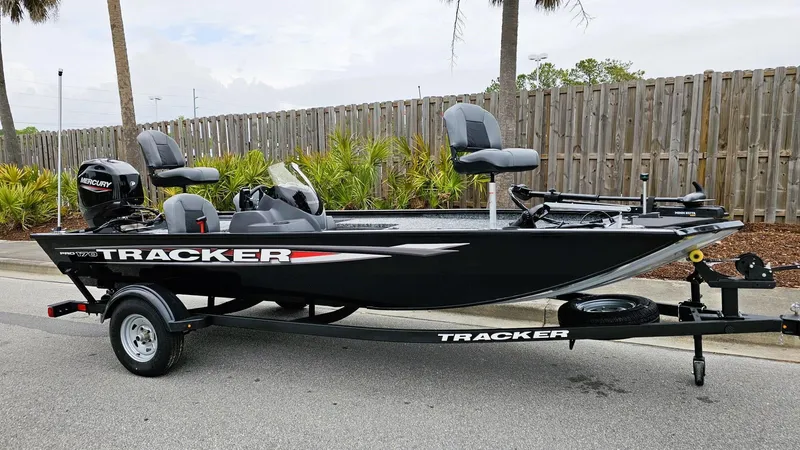 Slide: The Image of 2025 Tracker Pro 170 boat on trailer, parked outdoors, side view. - 2