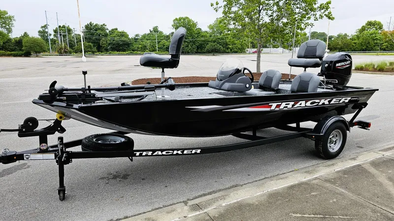 Slide: The Image of 2025 Tracker Pro 170 boat on trailer in parking lot, featuring sleek black design. - 3