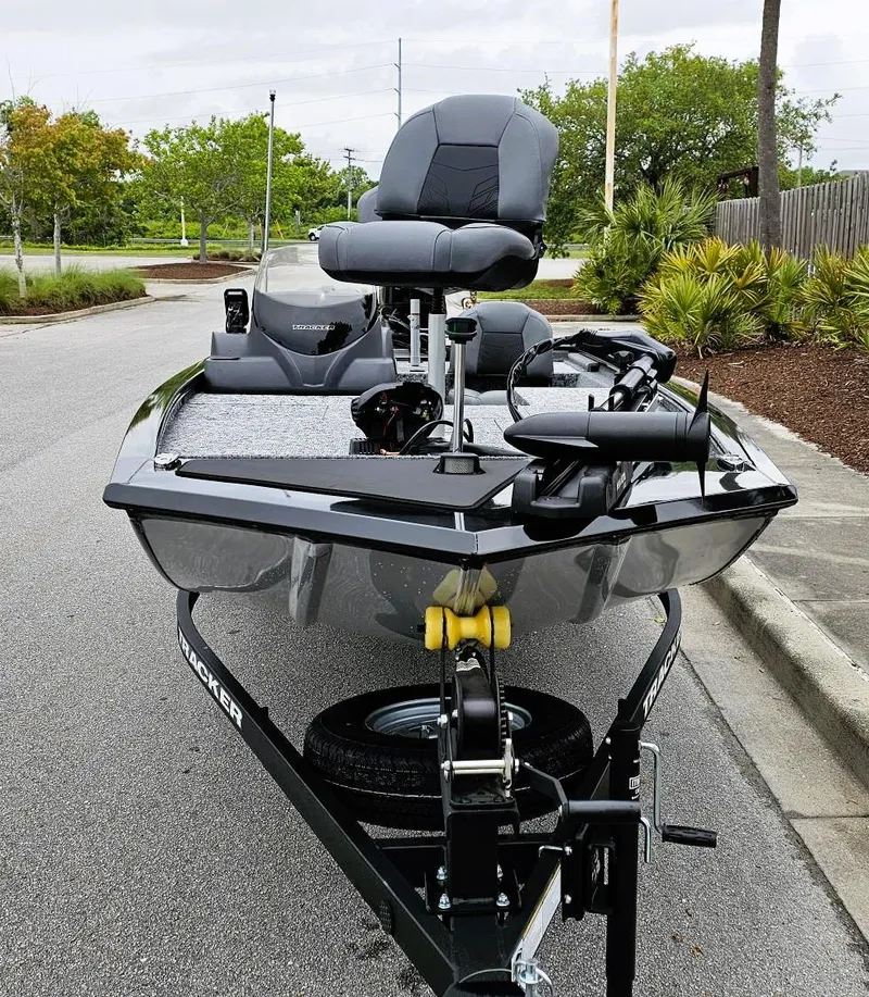Slide: The Image of 2025 Tracker Pro 170 boat on trailer, parked on street, with lush greenery in background. - 7