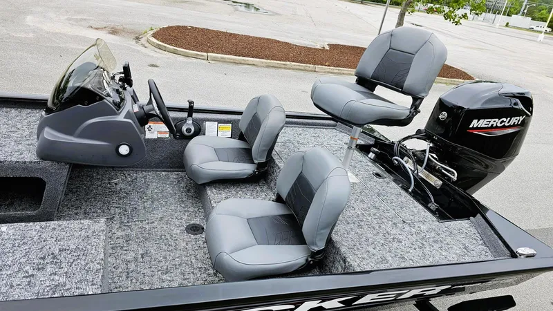 Slide: The Image of 2025 Tracker Pro 170 boat interior with gray seating and Mercury outboard motor. - 8