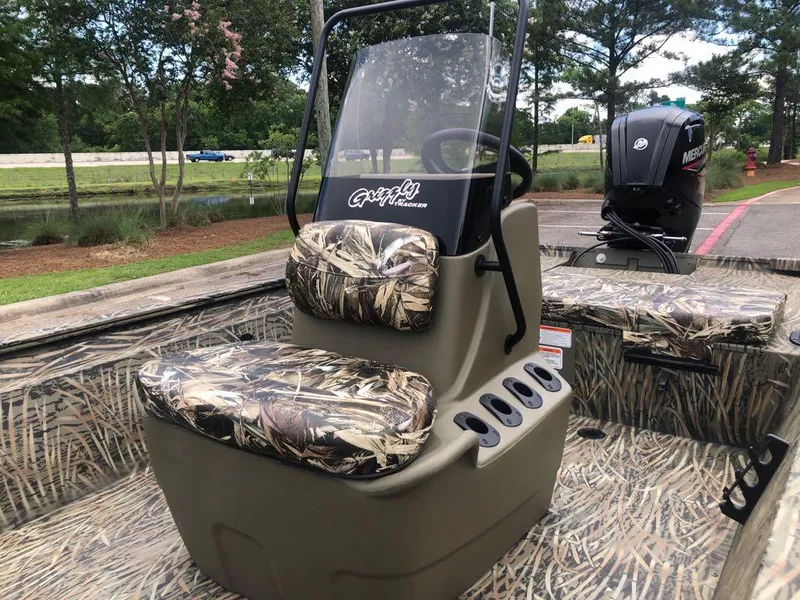 Slide: The Image of 2025 Tracker Grizzly 1860 CC boat with camo seats and Mercury outboard motor. - 10