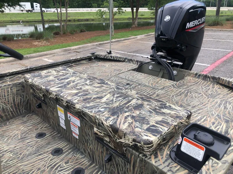 Slide: The Image of 2025 Tracker Grizzly 1860 CC boat with camouflage seating and Mercury outboard motor. - 12