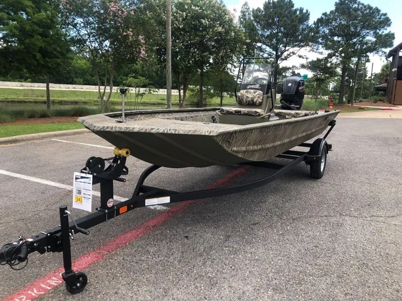 Slide: The Image of 2025 Tracker Grizzly 1860 CC boat on trailer in parking lot. - 13