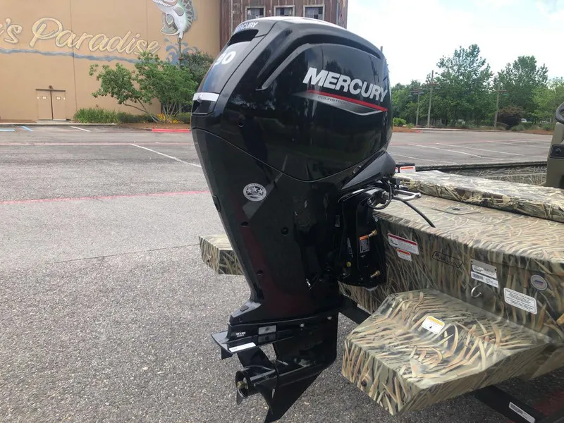 Slide: The Image of 2025 Tracker Grizzly 1860 CC boat with Mercury outboard motor in parking lot. - 3