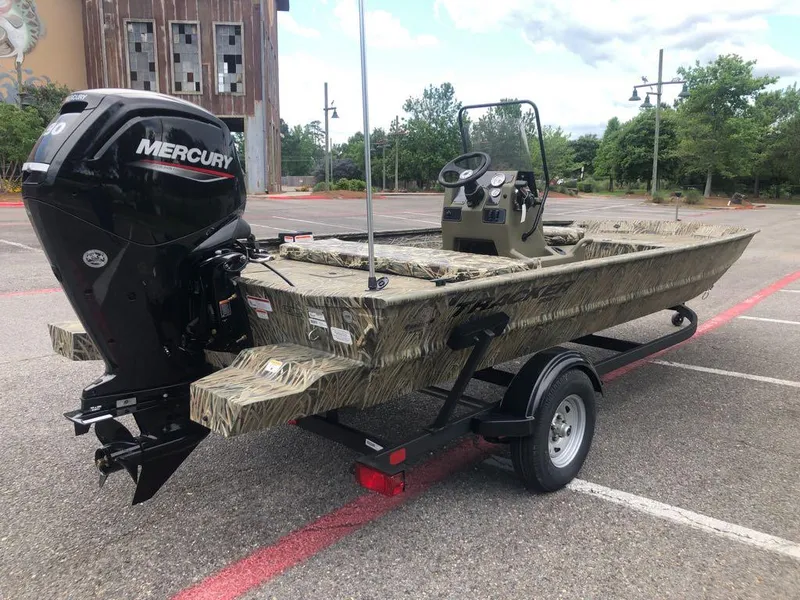 Slide: The Image of 2025 Tracker Grizzly 1860 CC boat with Mercury engine on trailer in parking lot. - 4