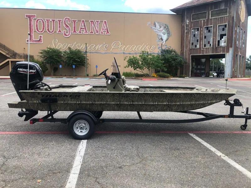 Slide: The Image of 2025 Tracker Grizzly 1860 CC boat on trailer, parked outside Louisiana store. - 5