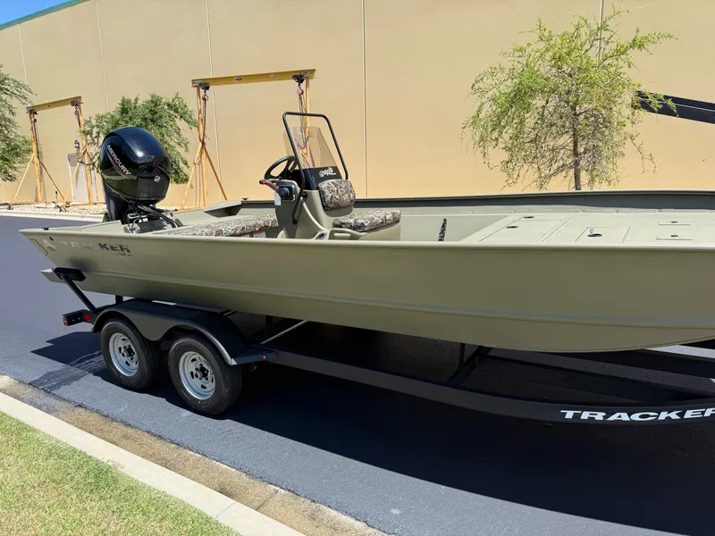 Slide: The Image of 2025 Tracker Grizzly 2072 CC boat on trailer, parked outdoors. - 3