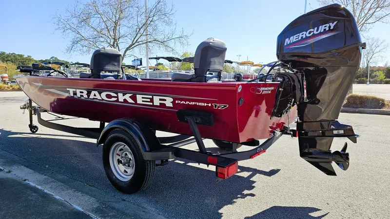 Slide: The Image of 2025 Tracker Panfish 17 boat with Mercury engine on trailer, parked outdoors. - 6