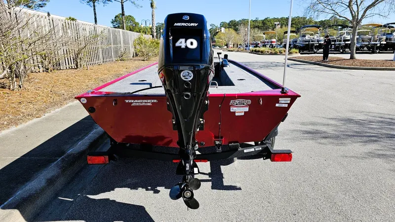 Slide: The Image of 2025 Tracker Panfish 17 boat with Mercury 40 engine, parked outdoors. - 7