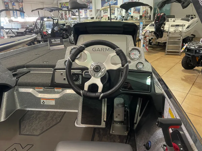 Slide: The Image of 2025 Nitro Z21 XL Pro boat dashboard with Garmin steering system in showroom. - 10