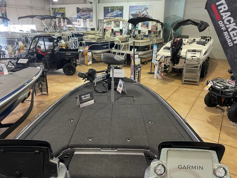 Slide: The Image of 2025 Nitro Z21 XL Pro boat displayed in a showroom with various marine equipment. - 12