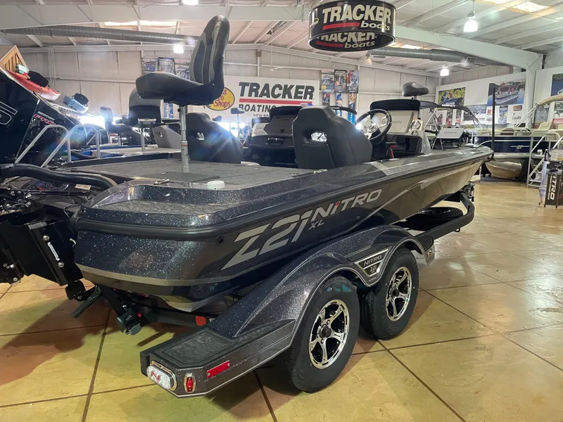Slide: The Image of 2025 Nitro Z21 XL Pro boat displayed in showroom with dual-axle trailer. - 3