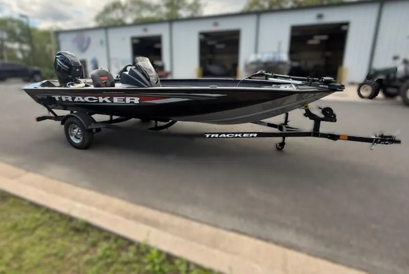 Slide: The Image of 2025 Tracker Pro Team 175 Crappie Edition boat on trailer, parked outside a building. - 4