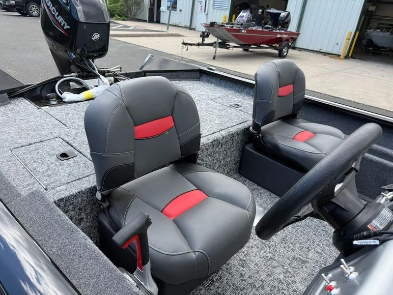 Slide: The Image of 2025 Tracker Pro Team 175 Crappie Edition boat interior with gray and red seats. - 5