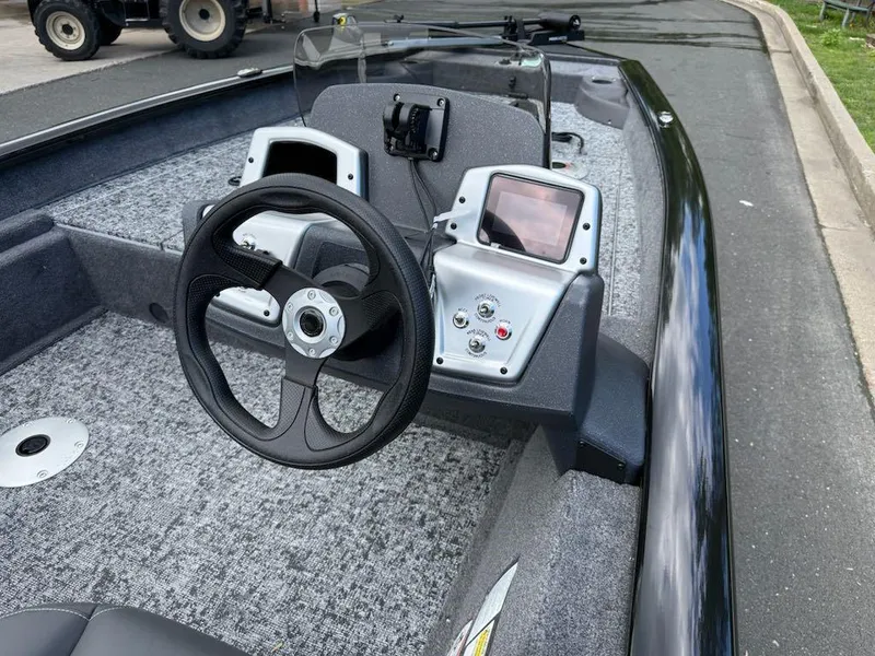 Slide: The Image of 2025 Tracker Pro Team 175 Crappie Edition boat interior with steering wheel and control panel. - 6