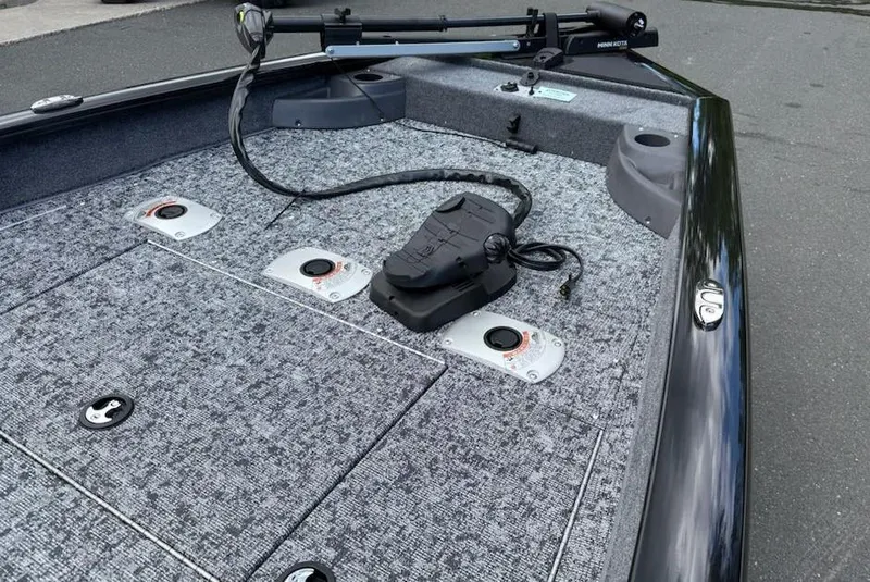 Slide: The Image of 2025 Tracker Pro Team 175 Crappie Edition boat deck with fishing rod holders. - 7