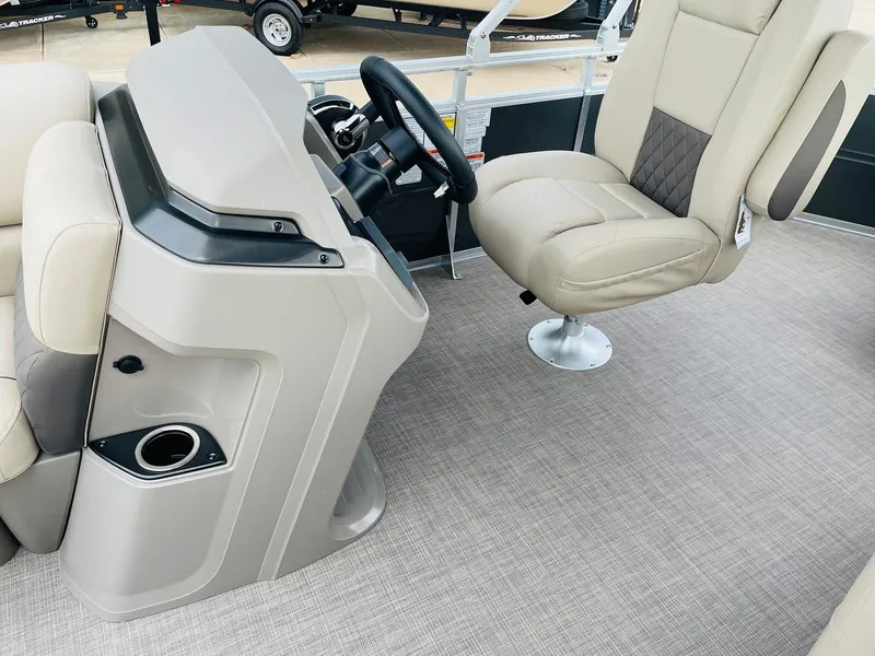 Slide: The Image of 2025 Sun Tracker Party Barge 20 DLX interior with steering console and captain's chair. - 19