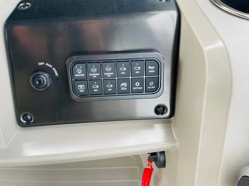 Slide: The Image of Control panel of 2025 Sun Tracker Party Barge 20 DLX with various switches and ignition. - 23
