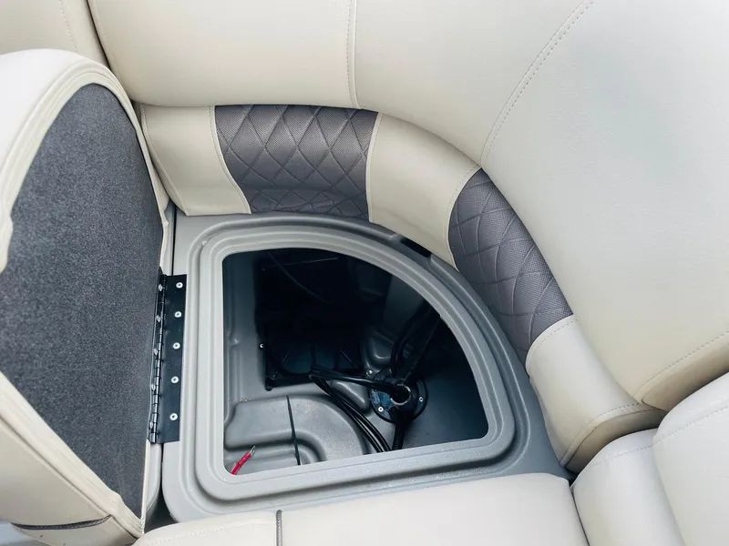 Slide: The Image of 2025 Sun Tracker Party Barge 20 DLX storage compartment with cushioned seating and quilted design. - 31