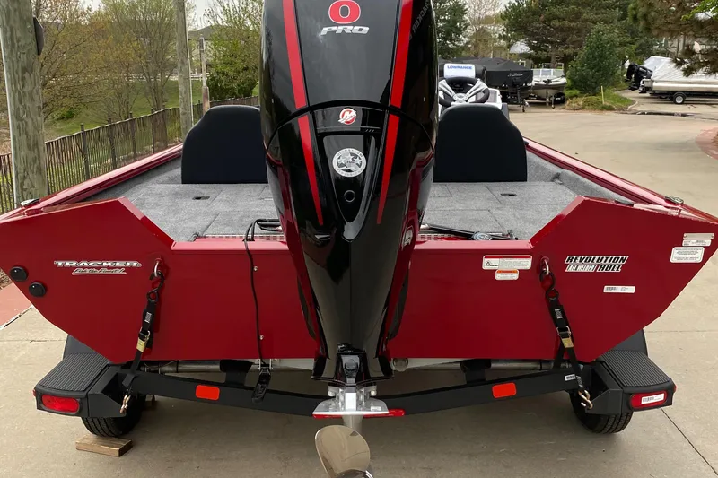 Slide: The Image of 2025 Tracker Pro Team 195 Tournament Edition boat, rear view, red color, on trailer. - 2