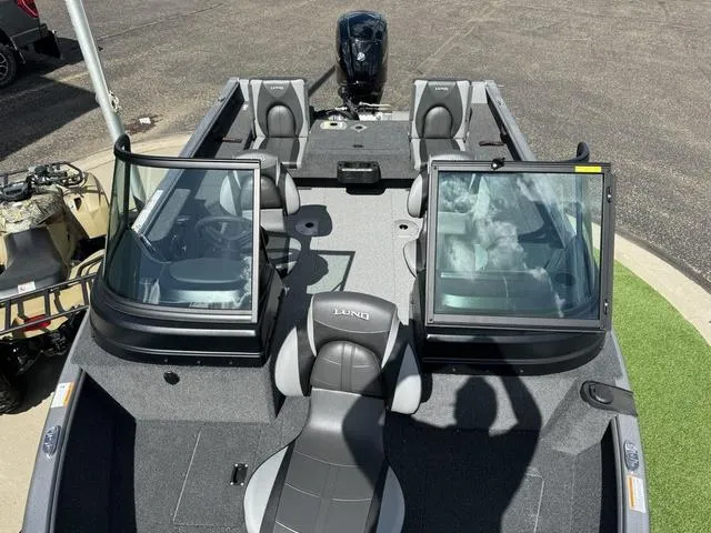 Slide: The Image of 2024 Lund 1775 Impact XS Sport boat with open windshield and seating. - 10