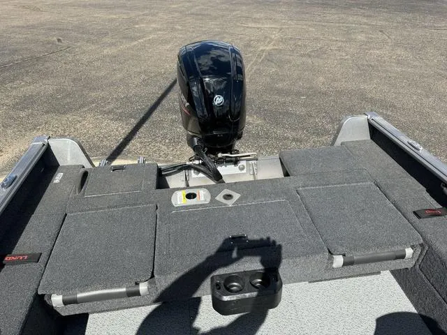 Slide: The Image of 2024 Lund 1775 Impact XS Sport boat with Mercury outboard motor, rear deck view. - 12