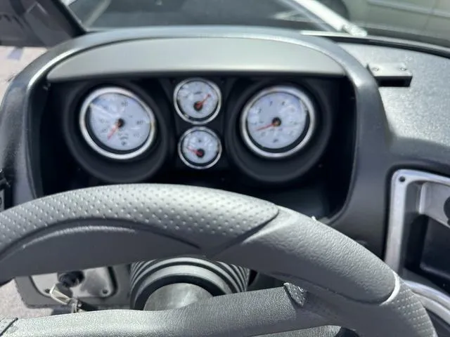 Slide: The Image of Dashboard of 2024 Lund 1775 Impact XS Sport boat with gauges and steering wheel. - 14