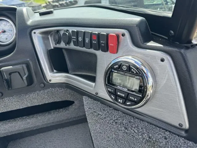 Slide: The Image of 2024 Lund 1775 Impact XS Sport dashboard with control panel and audio system. - 16