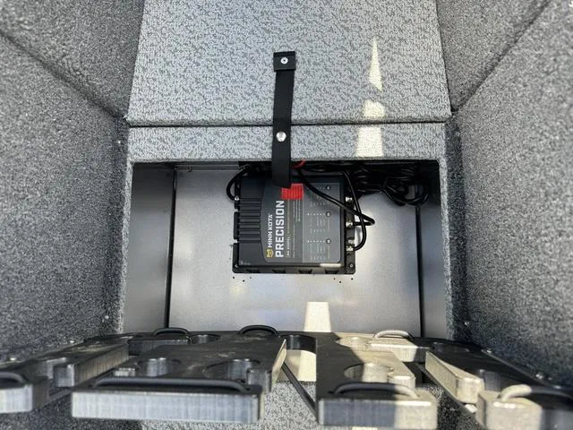 Slide: The Image of 2024 Lund 1775 Impact XS Sport boat battery compartment with precision charger. - 21