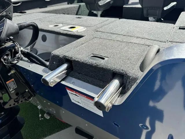 Slide: The Image of 2024 Lund 1775 Impact XS Sport boat interior with carpeted deck and metal fittings. - 27