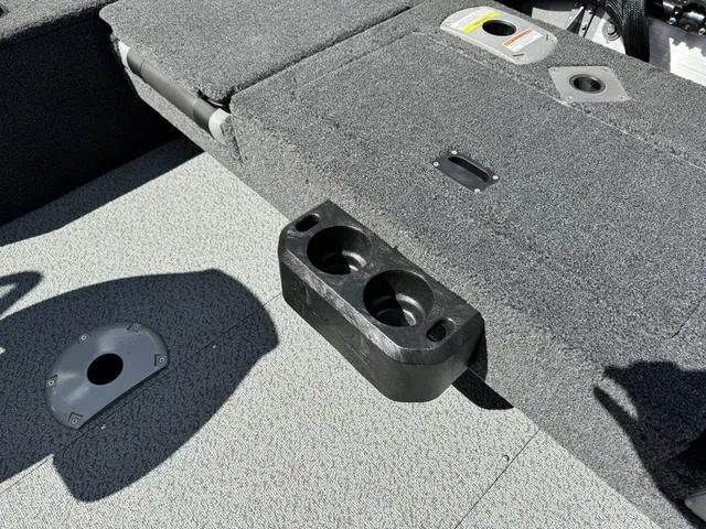 Slide: The Image of 2024 Lund 1775 Impact XS Sport boat interior with cup holders and storage compartments. - 28