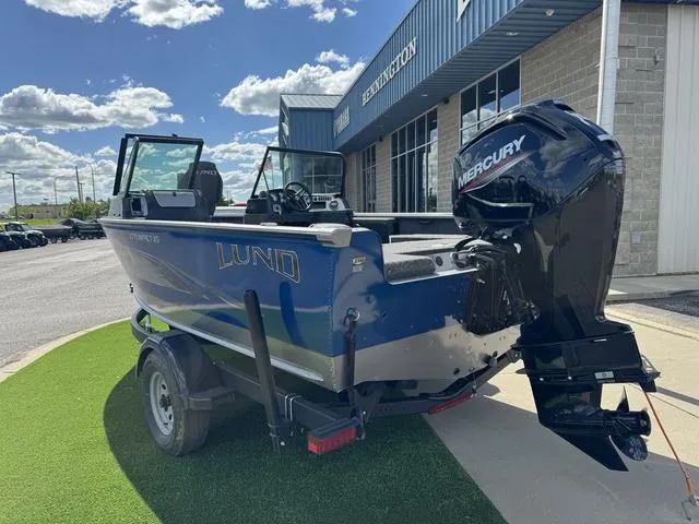 Slide: The Image of 2024 Lund 1775 Impact XS Sport boat with Mercury engine, parked outside dealership. - 3