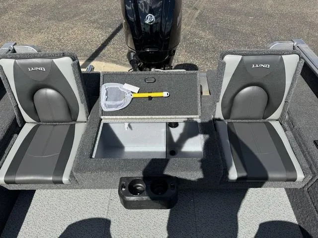 Slide: The Image of 2024 Lund 1775 Impact XS Sport boat interior with seating and storage compartments. - 8
