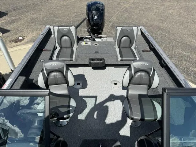 Slide: The Image of 2024 Lund 1775 Impact XS Sport boat interior with four seats and motor. - 9