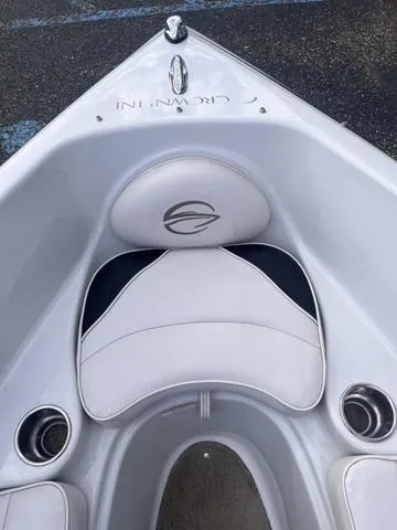 Slide: The Image of 2013 Crownline 18 SS boat interior with white seating and cup holders. - 11