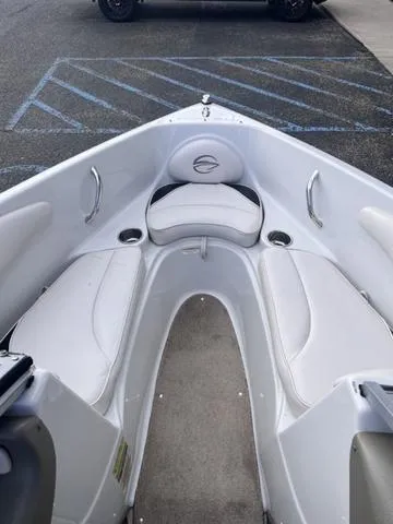 Slide: The Image of 2013 Crownline 18 SS boat interior with white seating and cup holders. - 13