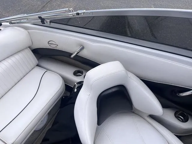 Slide: The Image of 2013 Crownline 18 SS boat interior with white leather seats and cup holders. - 15