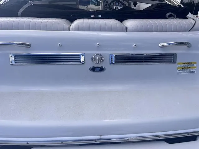 Slide: The Image of 2013 Crownline 18 SS boat interior with white seating and chrome accents. - 17