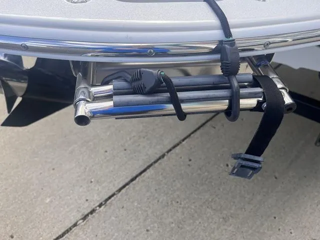 Slide: The Image of 2013 Crownline 18 SS boat ladder with secure straps on a concrete surface. - 19