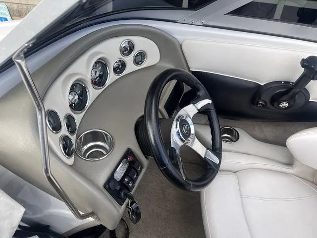 Slide: The Image of 2013 Crownline 18 SS boat interior with steering wheel and dashboard controls. - 20