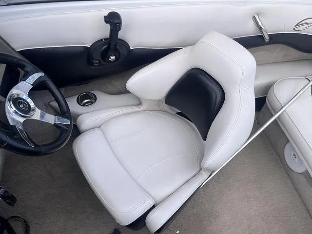 Slide: The Image of Interior of 2013 Crownline 18 SS boat with white seating and steering wheel. - 21