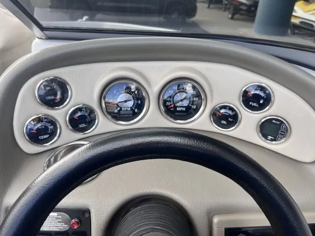 Slide: The Image of Dashboard of a 2013 Crownline 18 SS boat with various gauges and controls. - 22