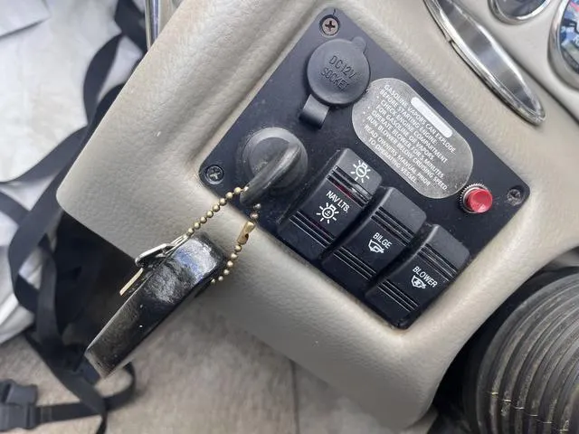 Slide: The Image of Control panel of a 2013 Crownline 18 SS boat with ignition and switches. - 24