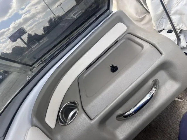 Slide: The Image of Interior view of a 2013 Crownline 18 SS boat dashboard with storage compartment. - 26